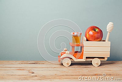 Jewish holiday Rosh Hashana background with toy truck, honey and apples Stock Photo