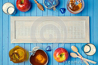 Jewish holiday Rosh Hashana background with wooden board, honey and apples on table. View from above. Stock Photo
