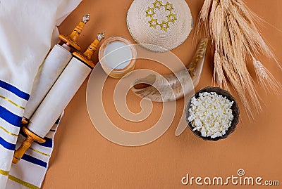 Jewish holiday Shavuot for kosher dairy food on torah scroll and tallis Stock Photo