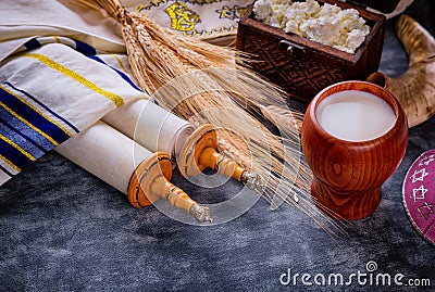 Jewish holiday Shavuot for kosher dairy food on torah scroll and tallis Stock Photo