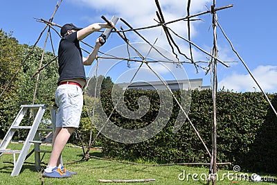 Jewish Man Building a Sukkah on Sukkoth Feast of Tabernacles Jewish Holiday Stock Photo