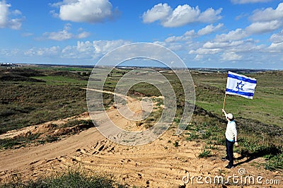 Jewish man fly flag of Israel near Gaza Strip Editorial Stock Photo