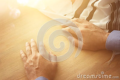 Jewish man hands next to tallit. Jewish traditional symbol. Rosh hashanah jewish New Year holiday, Shabbat and Yom kippur concep Stock Photo