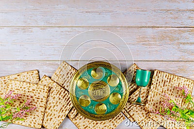 Jewish matzah, kiddush and seder with text in hebrew egg, bone, herbs, karpas, chazeret and charoset. Passover concept Stock Photo