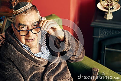 Jewish senior with glasses in the armchair Stock Photo