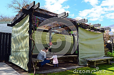 Jewish woman and child visiting their family Sukkah Stock Photo