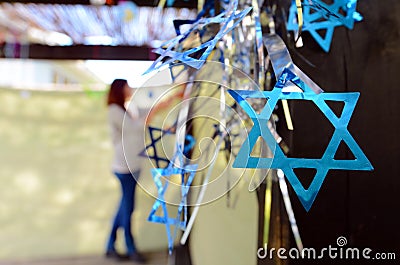 Jewish woman decorating here family Sukkah Stock Photo