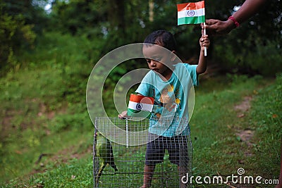 Little child holding Indian National Tricolor Flag with an older. Indian Independence Day or Editorial Stock Photo