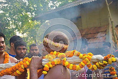 A priest bringing the holy water for the worship of Lord Shiva. the villagers enjoys the programme Editorial Stock Photo