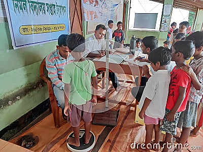 a doctors check up a students body at a primary school in rural india Editorial Stock Photo