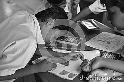Students hands holding colored pencils painting on art drawing paper Editorial Stock Photo