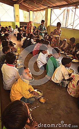 Mid day meal program, in an Indian government initiative, is being running in a primary school. Pupils are taking their meal. Editorial Stock Photo