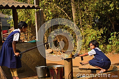 Two primary school girls are washing their hand and their dishes before taking Mid-day meal in a primary school of West Bengal Editorial Stock Photo