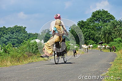 Jhargram, West Bengal , India - Senior old Indian Couple On Cycle Ride In Countryside in rural India Editorial Stock Photo