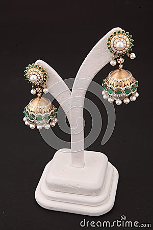 jhumki earring gold with white and green diamonds traditional wear for women Stock Photo