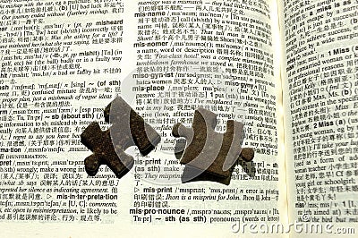 Jigsaw pieces on a dictionary Stock Photo