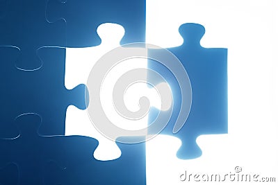 Jigsaw puzzle piece missing. Light glowing. Solution Stock Photo