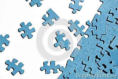 jigsaw puzzles on white background, partially assembled mosaic, many pieces of jigsaw puzzles, the concept of laborious work, fin Stock Photo