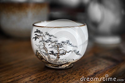 White ceramic cup with pine pattern. Stock Photo