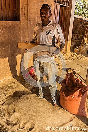 JINKA, ETHIOPIA - FEBRUARY 5, 2020: Teff grain seller in Jinka, Ethiop Editorial Stock Photo