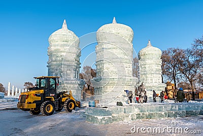 Jinlin, Changchun CHINA - DEC, 27 2018 : Workers are using tractor lifting ice cubes to build ice castles and build snow Editorial Stock Photo