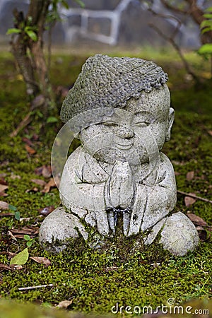 Jizo stone statue wearing knitted and cloth hats. Stock Photo