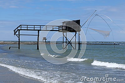 Joalland beach with a plaice fishing hut in waves Stock Photo
