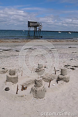 Joalland beach with a sandcastle and a plaice fishing hut Stock Photo