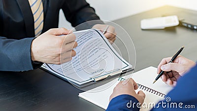 Job applicants, interview positions in modern office recruiters are reviewing and considering applicants, reading resume, Stock Photo