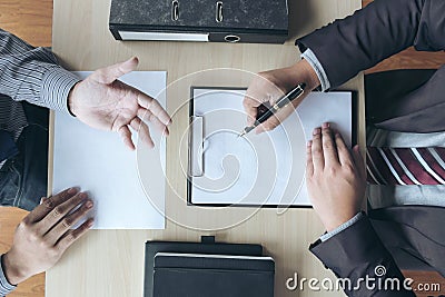 Job interview, Young attractive executives man asking questions Stock Photo