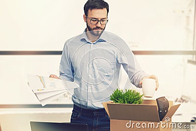 Job loss - fired man putting his belongings in cardboard box Stock Photo