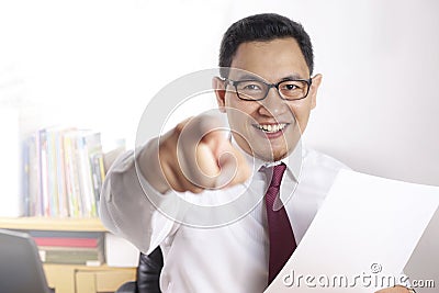 Job Offer Concept, Businessman Pointing Forward While Holding Empty Paper Stock Photo