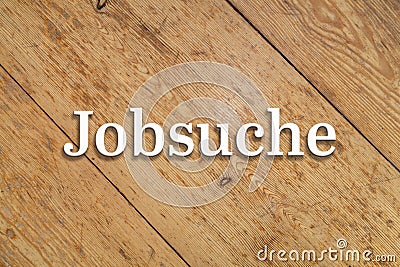 `Jobsuche` white text on a wooden background. Translation: Job search Stock Photo