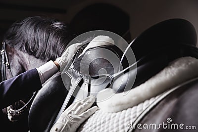 Jockey prepearing horse for the equestrian ride Stock Photo