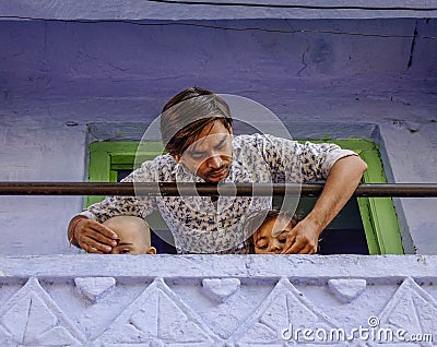 A young man with his children at rural house Editorial Stock Photo