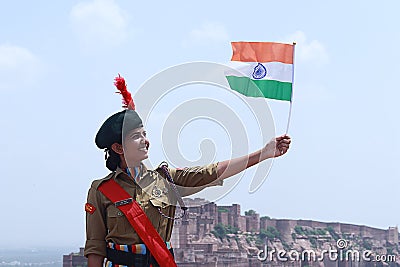 India`s National Cadet Corps NCC Lady Cadet Standing Holding Indian Flag, Editorial Stock Photo