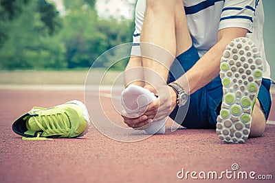 Jogger checking if his ankle is broken or twisted Stock Photo