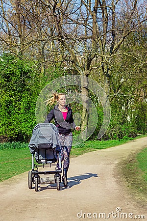 Jogging with a baby buggy Stock Photo