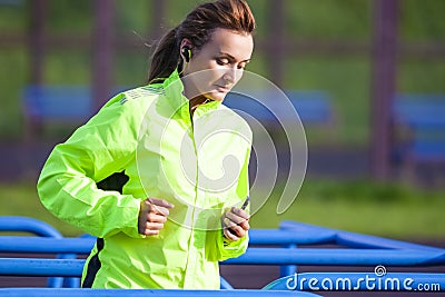 Professional Female Runner During Outdoor Training. Wearing Long Sleeve Jacket Stock Photo