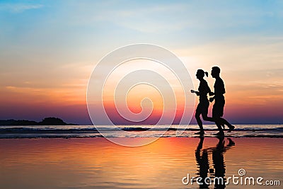 Jogging and healthy lifestyle, two runners silhouettes at sunset, workout and sport Stock Photo