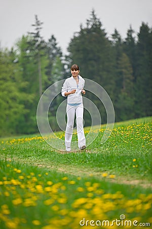 Jogging - sportive woman running in park Stock Photo