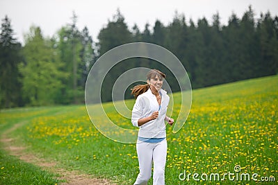 Jogging - sportive woman running in park Stock Photo