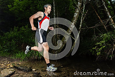 Jogging through a streambed Stock Photo
