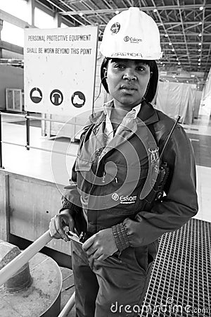 Female Technician in turbine room at Coal Burning Power Station Editorial Stock Photo