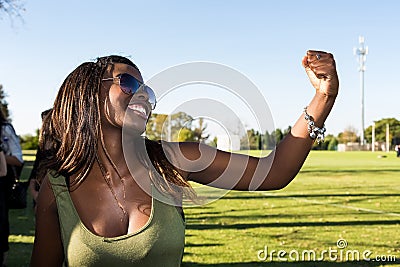 Young African girl flexing arm muscles in show of feminist power Editorial Stock Photo