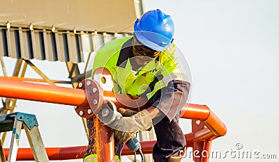 Tradesman working with an angle grinder on a building site Editorial Stock Photo