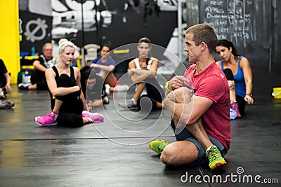 Personal Trainer giving fitness instruction at a Crossfit group class Editorial Stock Photo