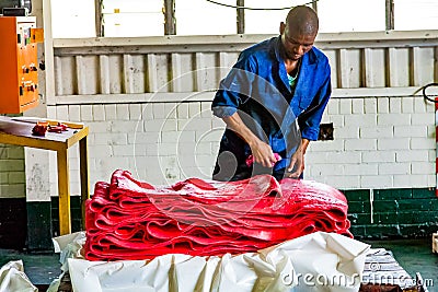 Diverse people working on an assembly line in a rubber factory Editorial Stock Photo