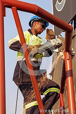 Tradesman working with an angle grinder Editorial Stock Photo