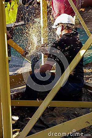 Tradesman working with an angle grinder Editorial Stock Photo